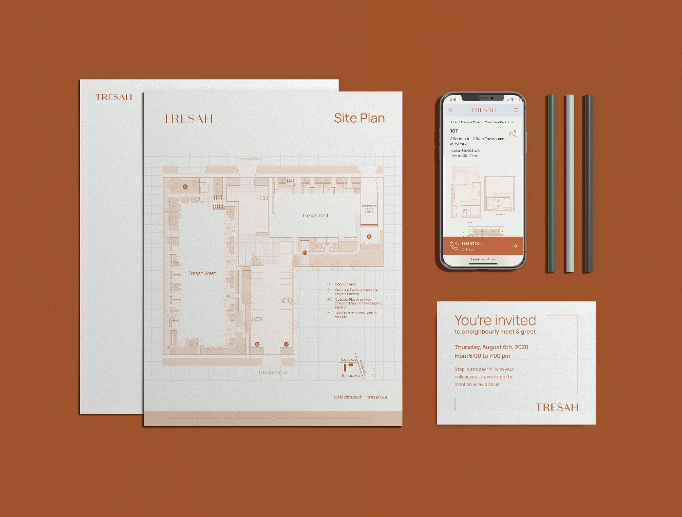 Tresah branded floor plan, invitation, mobile phone displaying website, and pens.