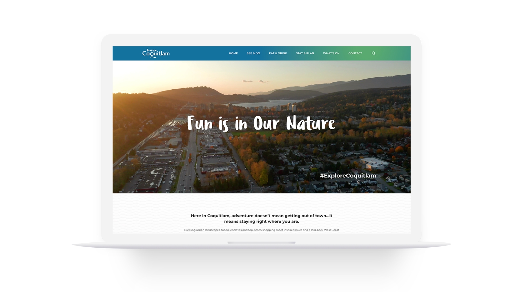 A laptop screen displaying the homepage of the Tourism Coquitlam website. The main banner shows an aerial view of the city at sunset with the text "Fun is in Our Nature" written across it. The website navigation bar includes options such as "See & Do," "Eat & Drink," "Stay & Plan," and "What's On."