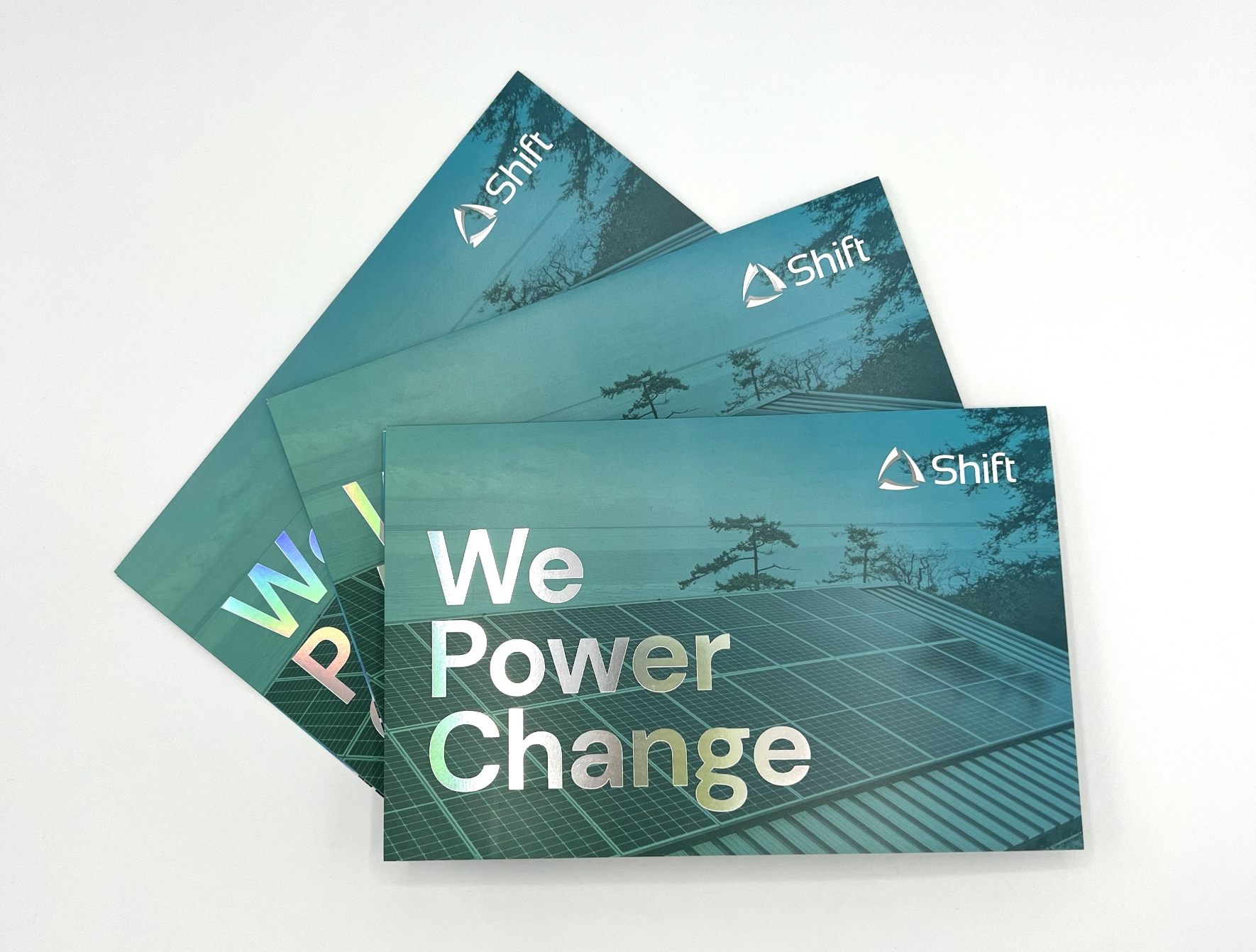 Marketing collateral with holographic foil-printing, highlighting Shift Energy's sustainability solutions.